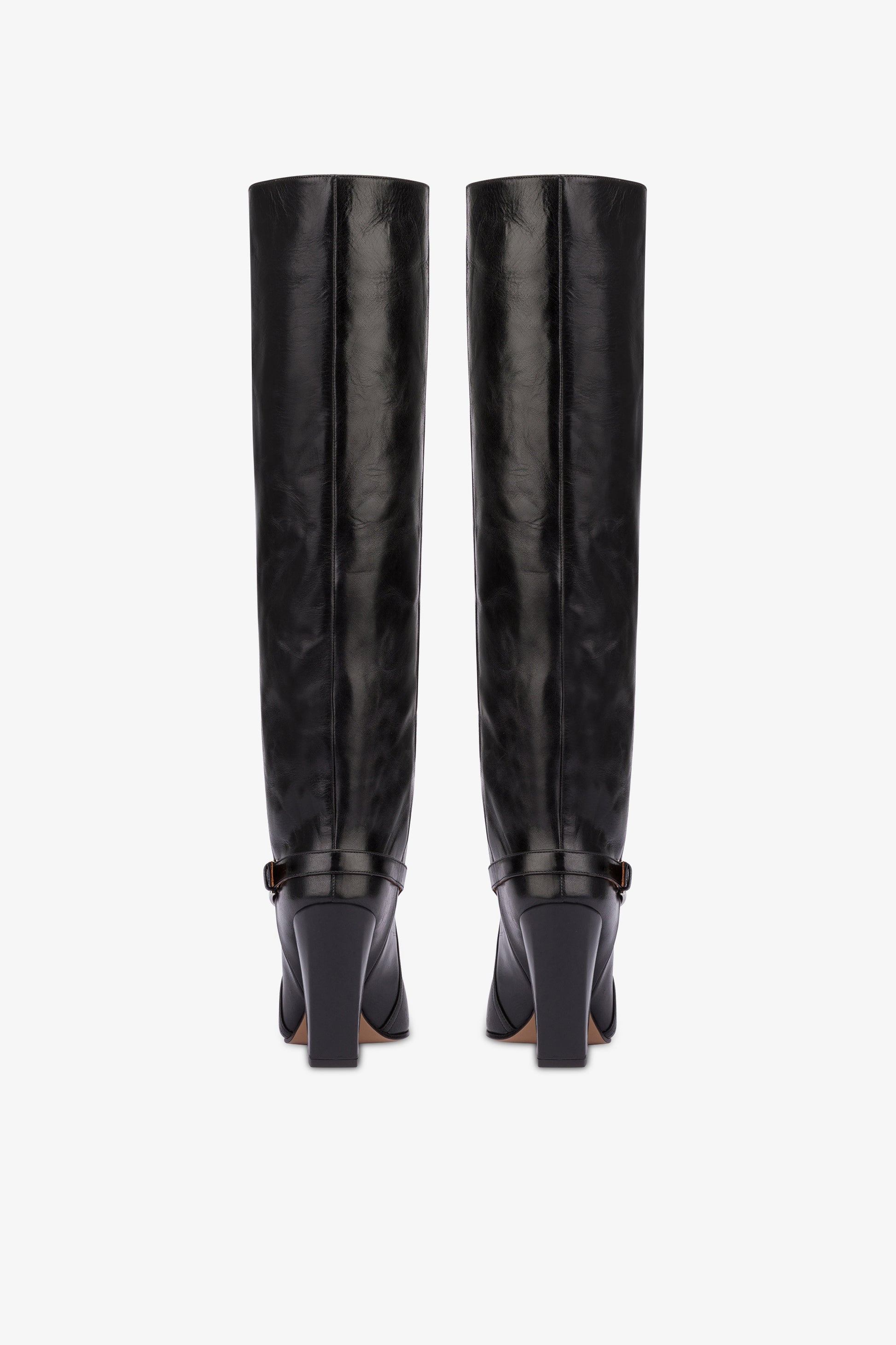 Tall, knee-high boots in shiny black vintage leather