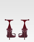 Sandals in rouge noir patent leather