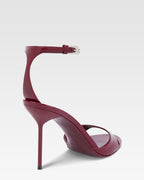 Sandals in rouge noir patent leather