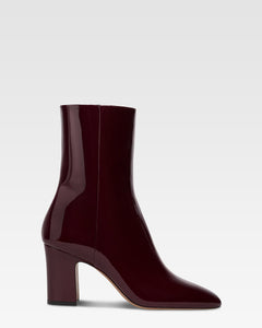 Ankle boots in rouge noir patent leather.