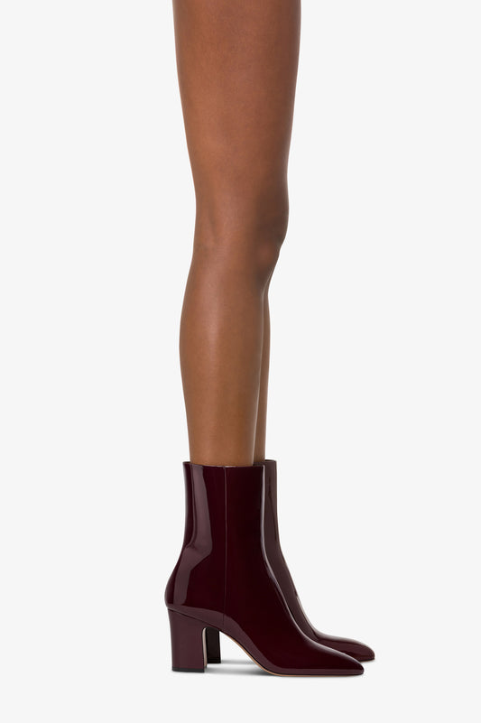 Ankle boots in rouge noir patent leather.