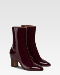 Ankle boots in rouge noir patent leather.
