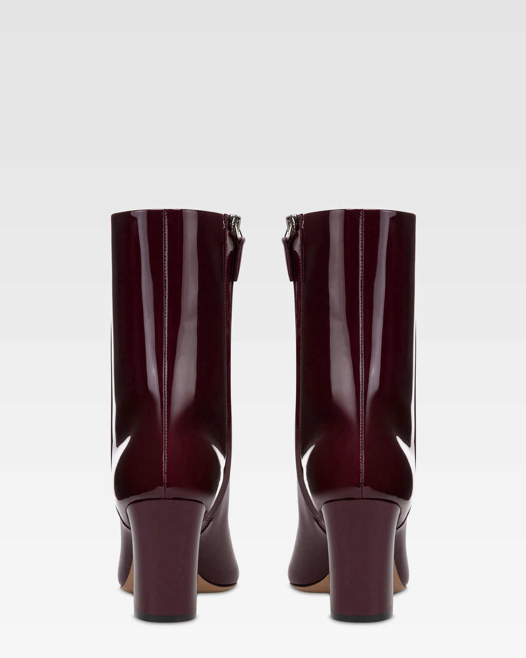 Ankle boots in rouge noir patent leather.