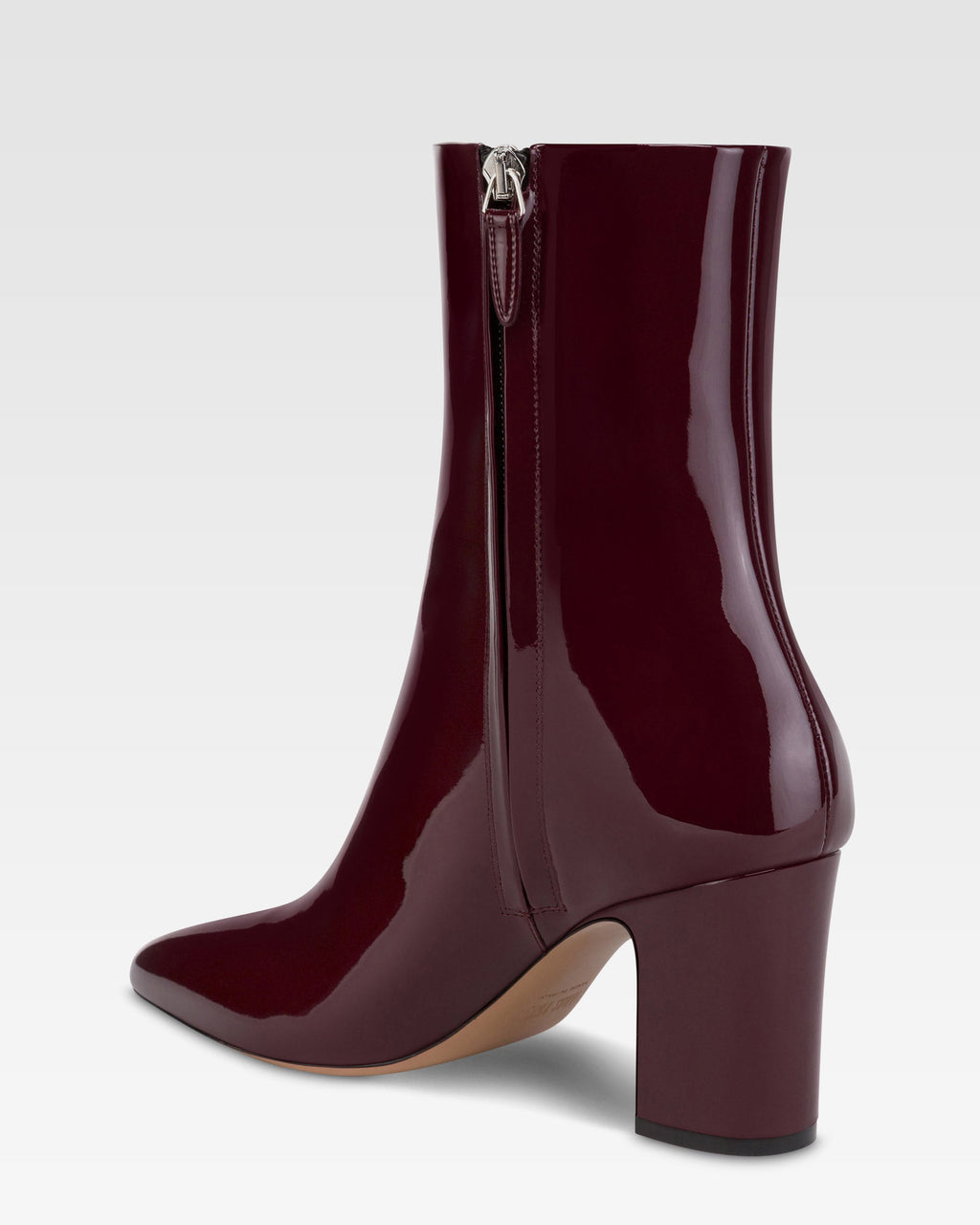 Ankle boots in rouge noir patent leather.
