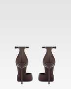 Ankle-strap pumps in ebony patent leather