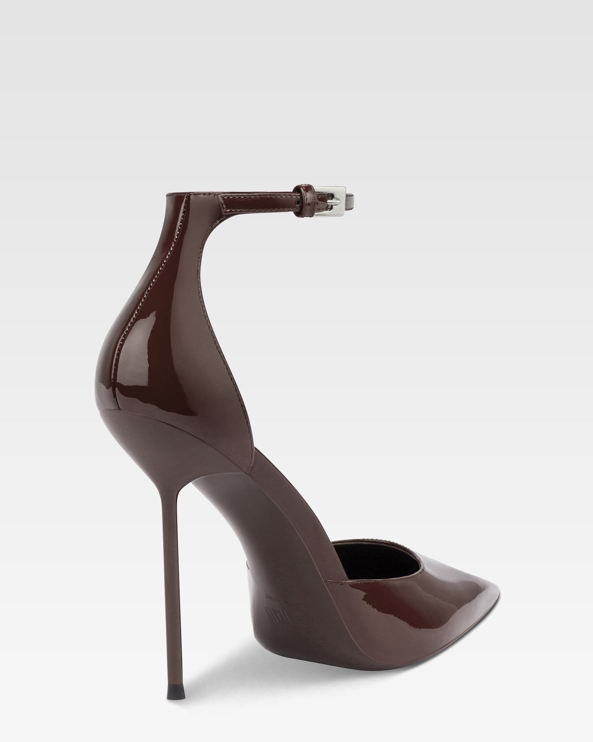 Ankle-strap pumps in ebony patent leather