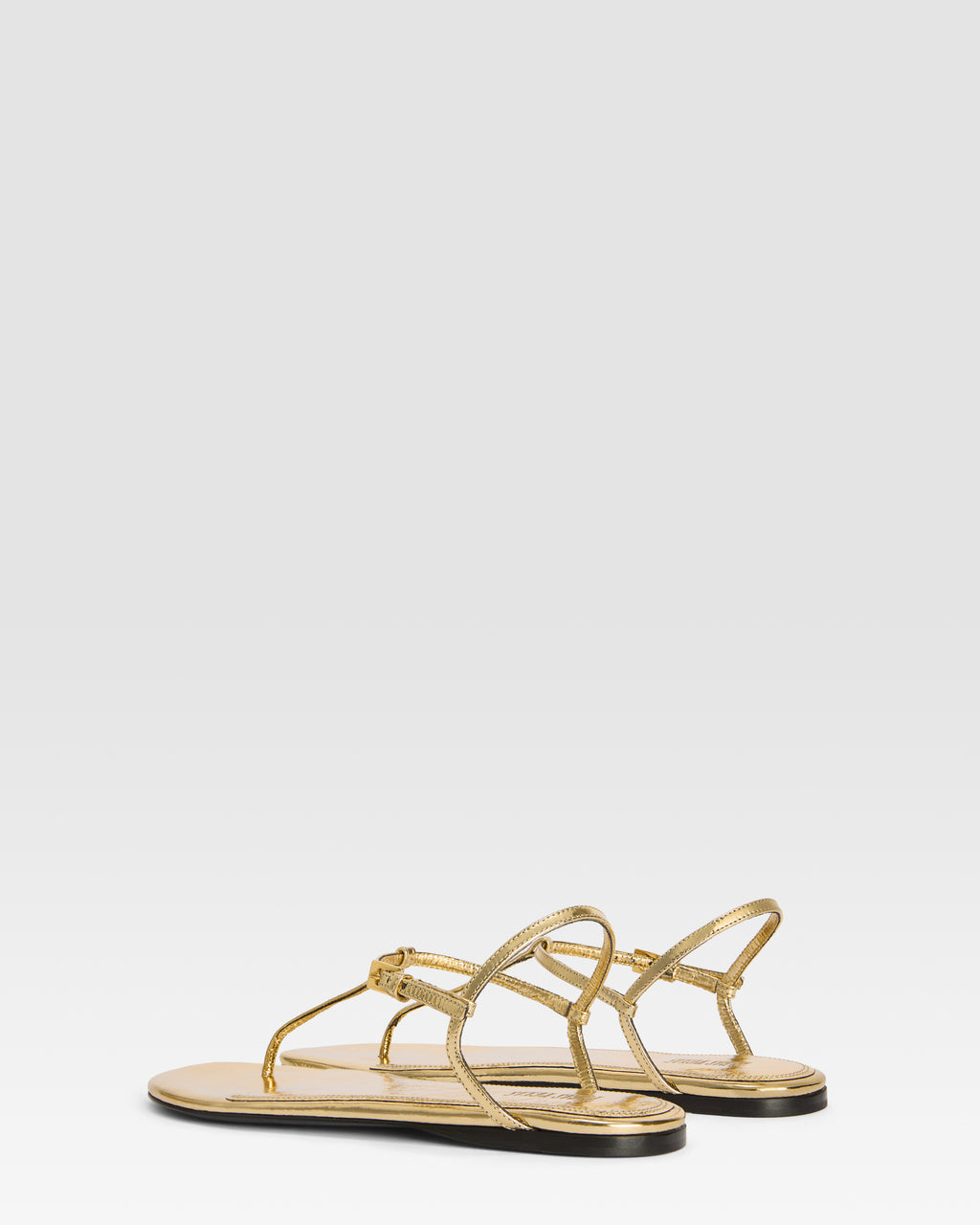 Flache Sandalen aus goldfarbenem Plissee-Leder mit Metallic-Effekt