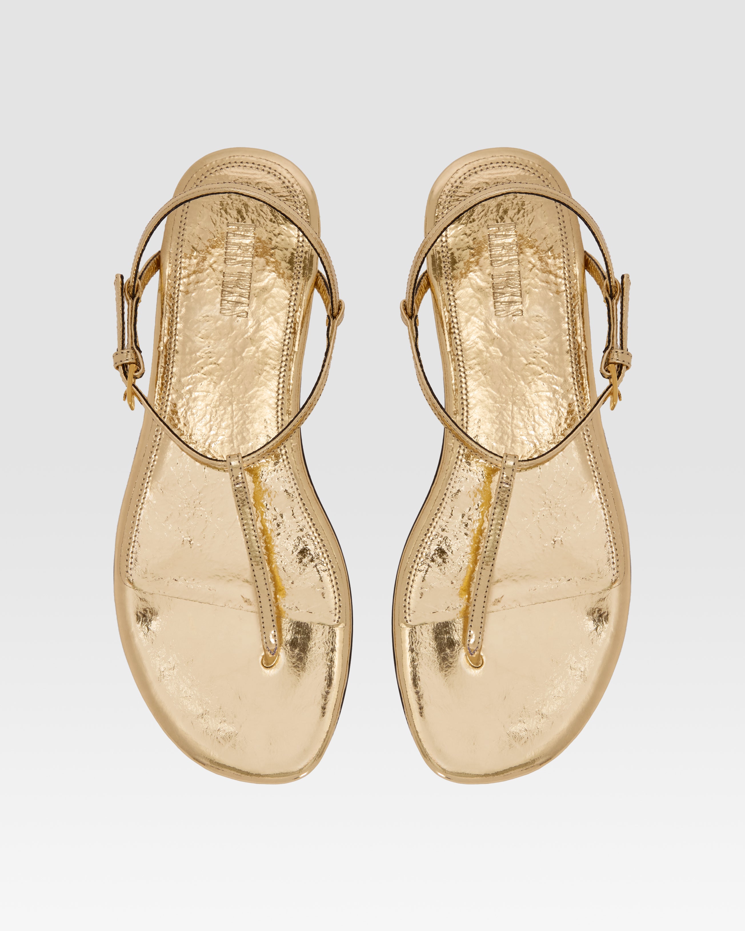 Flache Sandalen aus goldfarbenem Plissee-Leder mit Metallic-Effekt