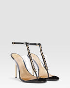 T-strap sandals in black patent leather with stud detailing