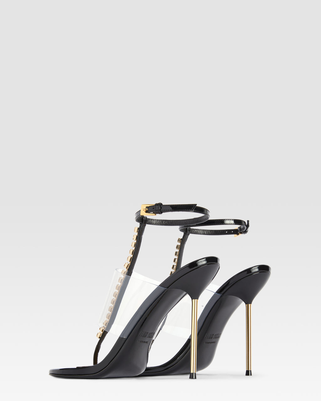 T-strap sandals in black patent leather with stud detailing