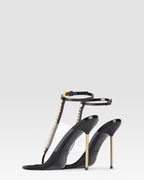 T-strap sandals in black patent leather with stud detailing