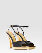 Ankle-strap sandals in shiny gold and black calf leather