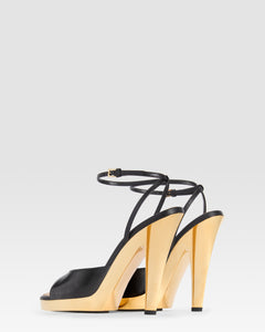 Ankle-strap sandals in shiny gold and black calf leather