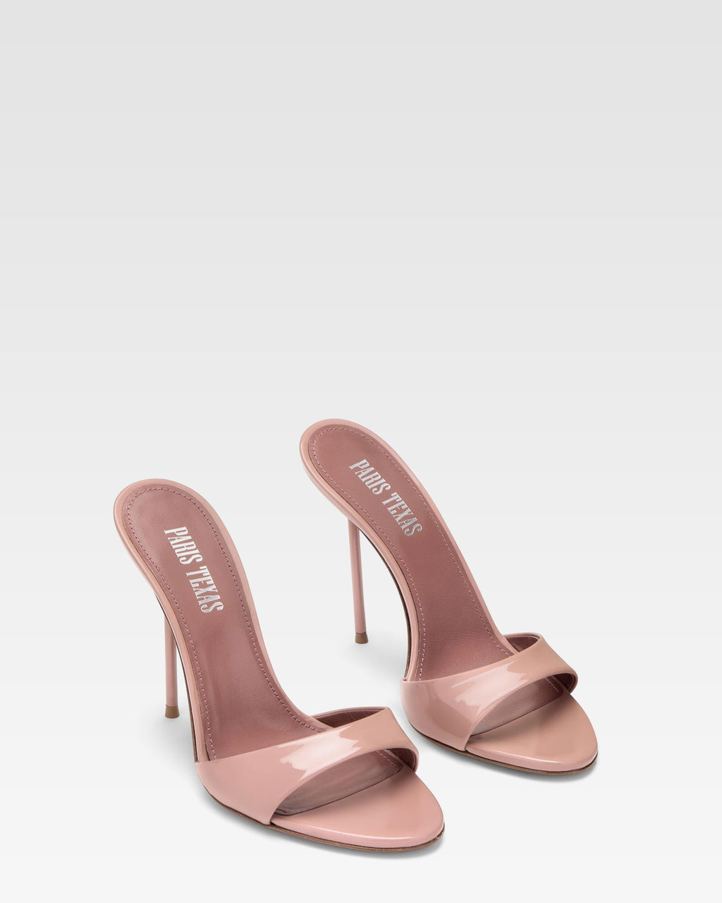 Mules in patent pink
